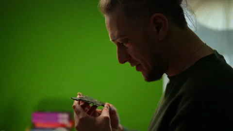 Side view of concentrated technician carefully examining motherboard Stock Footage 301400520