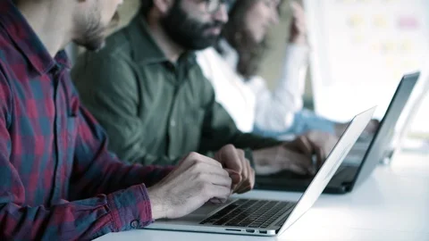 Side view of confident programmers working with laptops Stock Footage 121401103