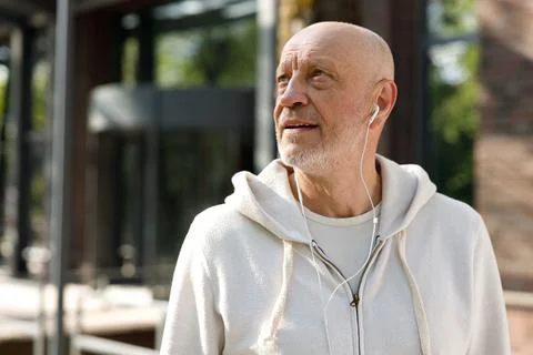 Side View of the Cool Mature Smiling Man Wearing Headphones. Sporty Positive Man Stock Photos
