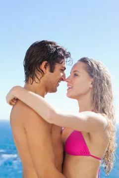 Side view of couple embracing in the pool 스톡 사진
