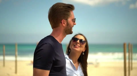 Side view couple walking along promenade Stock Footage 62666996