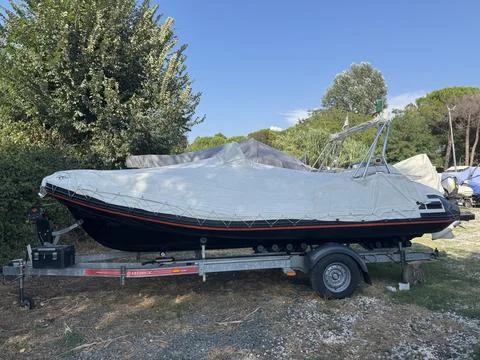 Side view of covered rigid inflatable boat  Stock Photos