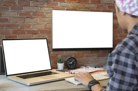 Side view of creative male freelancer working on design project with laptop.. Stock Photos