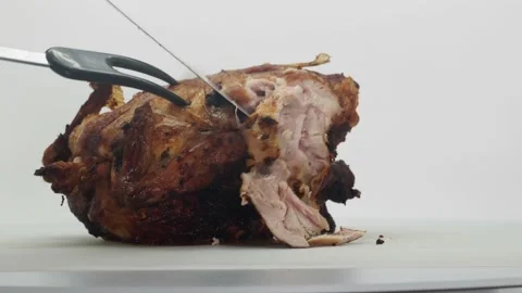 Side View Of A Crispy Roast Chicken, Being Sliced Up, On A White Background Stock Footage 143092827