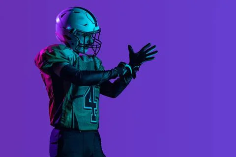 Side view cropped image of professional american footbal player in special Stock Photos