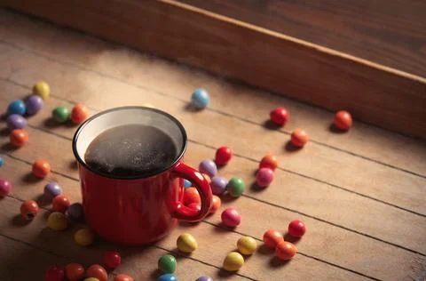 Side view on cup of coffee and Easter eggs on wooden table Stock Photos