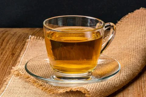 Side view of a cup of hot tea on sack cloth. Foto stock
