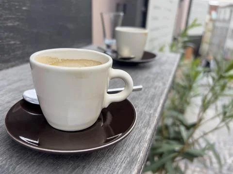 Side view cups of coffee on table or windowsill of a cafe Stock Photos