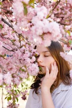 Side View of the Cute Lady With Brown Hair Covering Half of Face With Branches Stock Photos