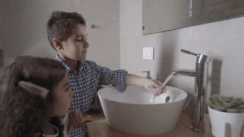 Side view of cute little arab children brother and sister wash their hands Stock Footage 113748727