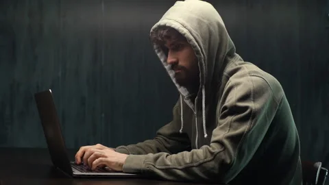 Side view of dangerous concentrated young bearded man hacking online web site in Video stock 142510520