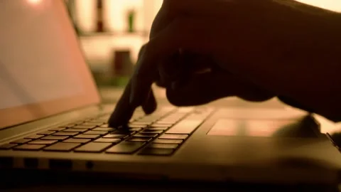 Side view dark silhouette of a man typing on a laptop keyboard. A male manager 스톡 동영상 238823461