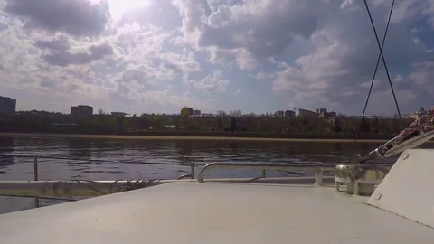 Side view from deck white steel yachts at the spring coast and city Stock Footage 75916712