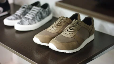 A side view demonstration showing closely several pairs of training shoes with a Stock Footage 131973434