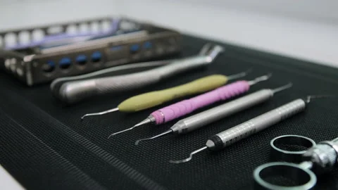 Side view of Dentist tools on black mat. In focus the edge of the dental tool Stock Footage 131483624