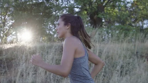 Side view of determined female athlete running on field Stock Footage