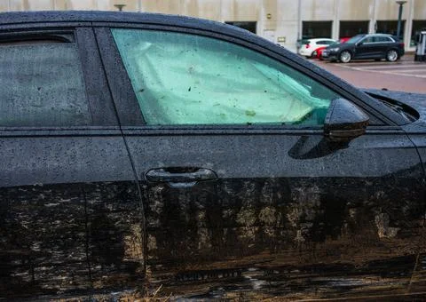 Side view of dirty car with deployed airbag. Stock Photos