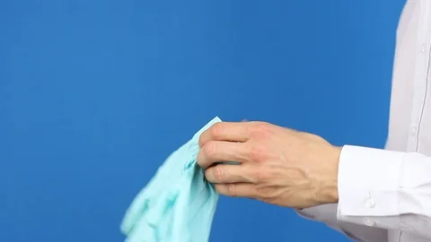 Side view, doctor puts on surgery or medical gloves, protection virus pollution Video stock 126998935