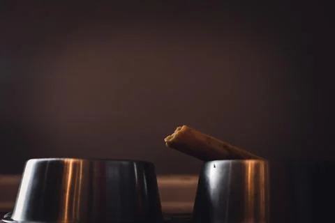Side view of a dog chew bone with a metal bowl Stock Photos