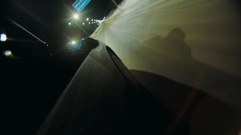 Side view of the door of a black car drived on a freeway at night in winter Stock Footage 249669056