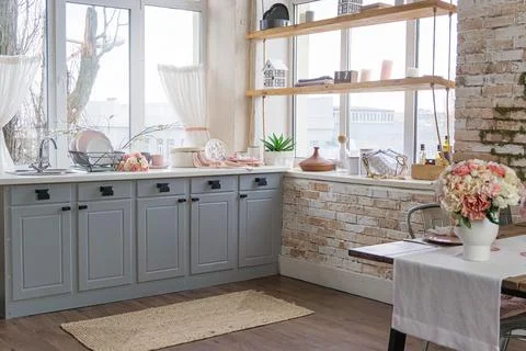 Side view of dreamy cute kitchen and a flowers on rusty wooden table Stock Photos
