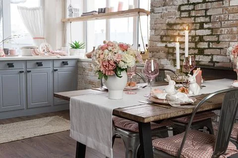 Side view on a dreamy table decor with glasses flowers and lit candles. Weddi Stock Photos