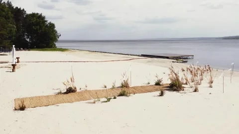 Side view of a drone flying around wedding ceremony design with straw rug and Stock Footage 321944255