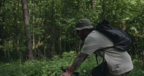 Side view of eco commuter riding through forest Stock Footage 311934778