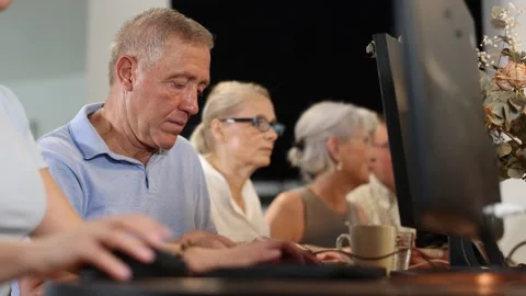 Side view of elderly people while studying in computer class in nursing home Stock Footage 279958972