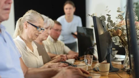 Side view of elderly people while studying in computer class in nursing home Stock Footage 329393169