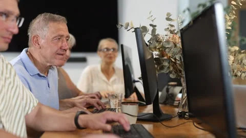 Side view of elderly people while studying in computer class in nursing home Stock Footage 341525531