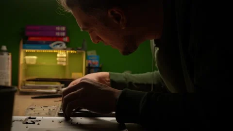 Side view of electronic technician carefully examining and repairing laptop Stock Footage 301401590