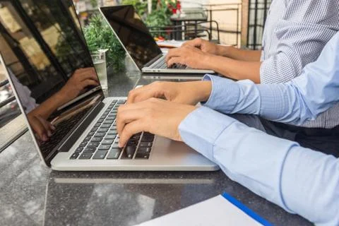Side view of employee hand working on laptop Stock Photos