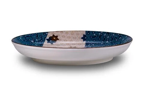 Side view of empty blue and brown star pattern dark edge ceramic plate. Stock Photos