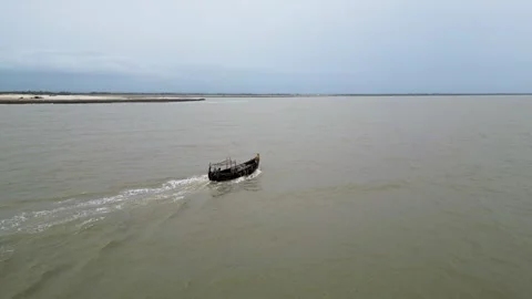 Side view of an engine-powered boat navigating through dirty, murky sea water Stock Footage 287779638