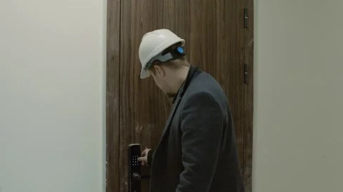 Side view of engineer in a suit and hardhat standing on a construction site. Stock Footage 323173452