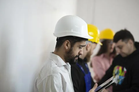 Side view of engineer in white hardhat Stock Photos