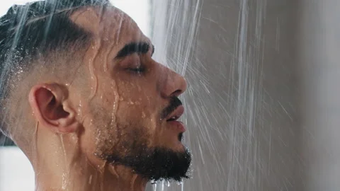 Side view extreme close-up arab spaniard man bearded male naked wet guy stands Stock Footage 171170442
