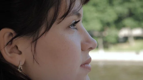 Side View Of Face Of Young Attractive Caucasian Woman Examines With Interest Stock Footage 113335148