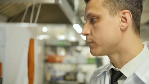 A side view face of young man looks hungry at the kitchen of the restaurant Video stock 75413416