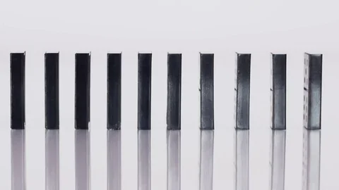 Side view of falling dominoes Stock Footage 70210543