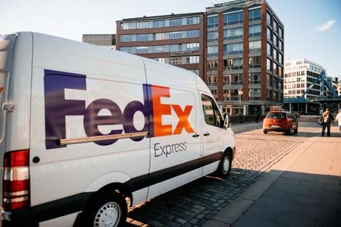 Side view of FedEx Express parcel delivery van driving fast Photos