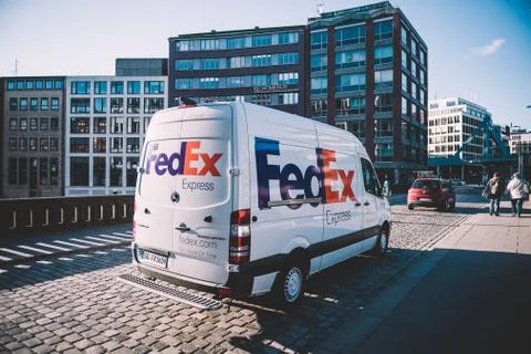 Side view of FedEx Express parcel delivery van driving fast Fotos de archivo