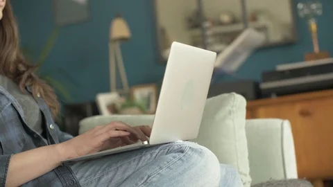 Side View Of Female Blogger Using Laptop On Sofa Stock Footage 79657397