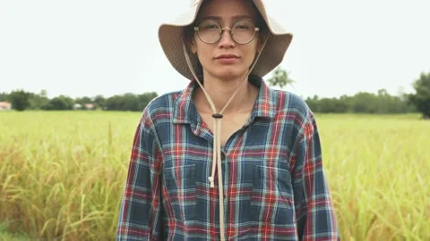 Side view of Female farmer standing in paddy field, portrait of woman farm worke Stock Footage 141355285