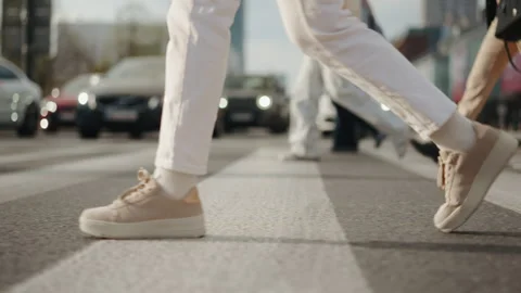 Side view female feet steps walking zebra crosswalk street low angle people legs Stock Footage 308041881