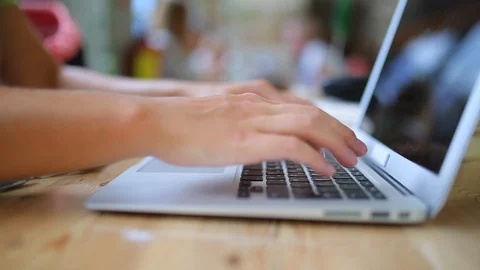 Side view female hands typing on a laptop keyboard Stock Footage