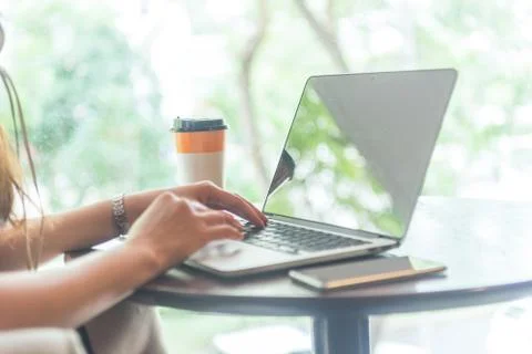 Side view of female hands using laptop Stock-Fotos