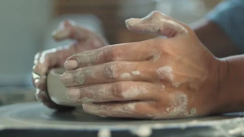 Side view of female potter making ceramic pot on the twisted pottery wheel. Video stock 143616595