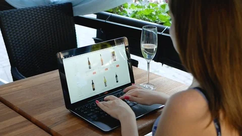 Side view of female using her laptop at a cafe. Overhead shot of young woman Video stock 100760012